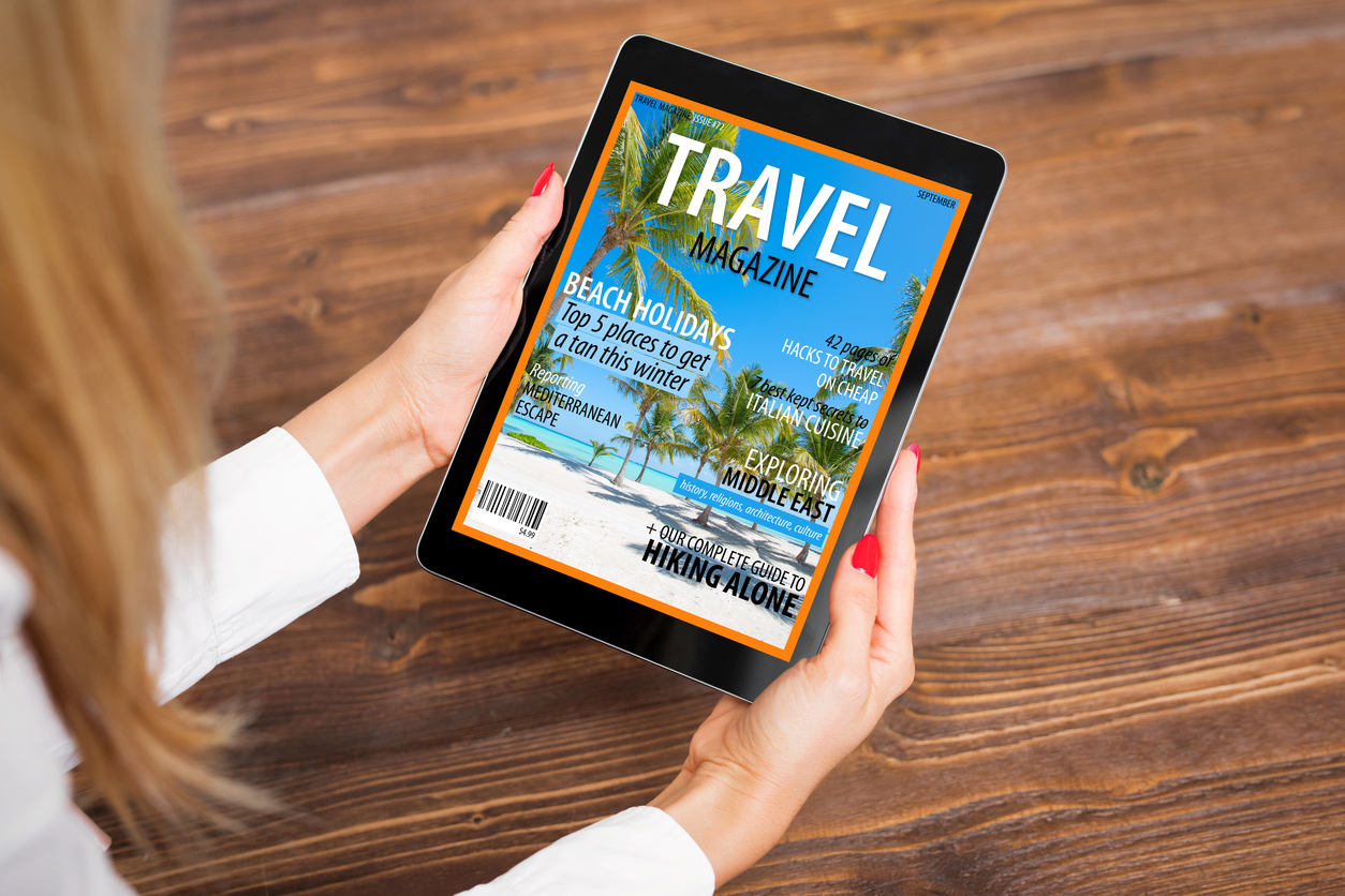 Reading travel magazine on tablet